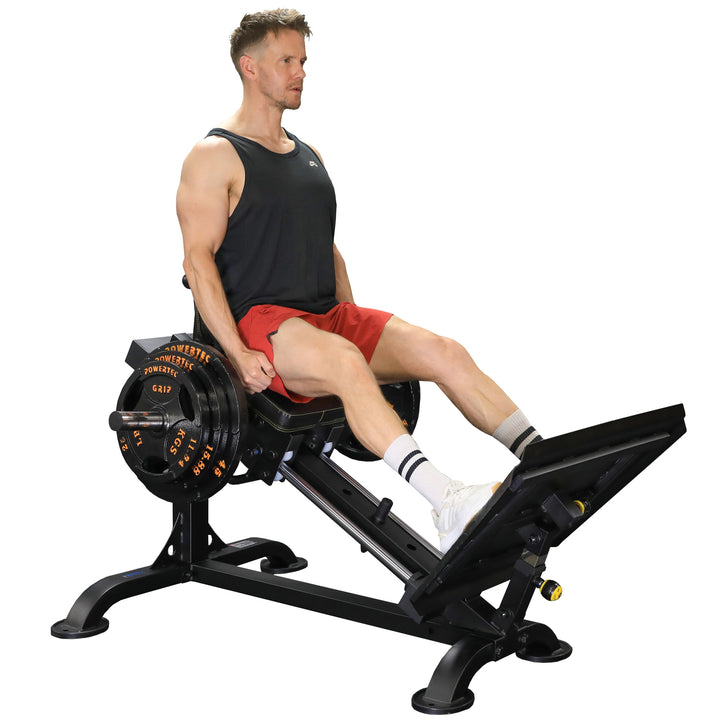 Side view of sled seat and adjustable back pad with footplate and hand grip setup for ergonomic leg press posture.