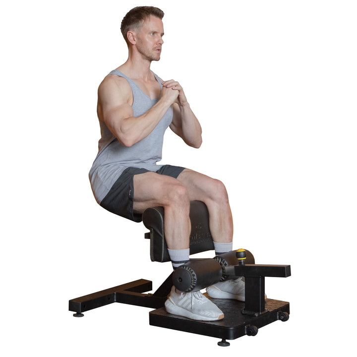 Powertec Sissy Squat Pro machine with a person performing a squat, showcasing quad isolation in a home gym setting.