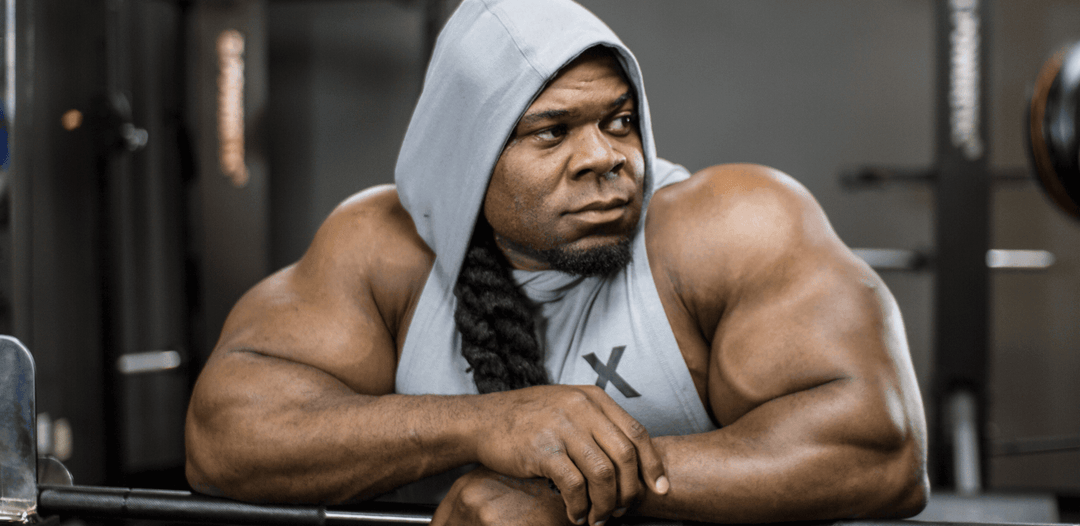 Kai Greene posing confidently after a workout.